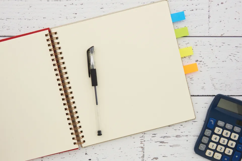 A calculator and paperwork, representing an itemised cloud bill