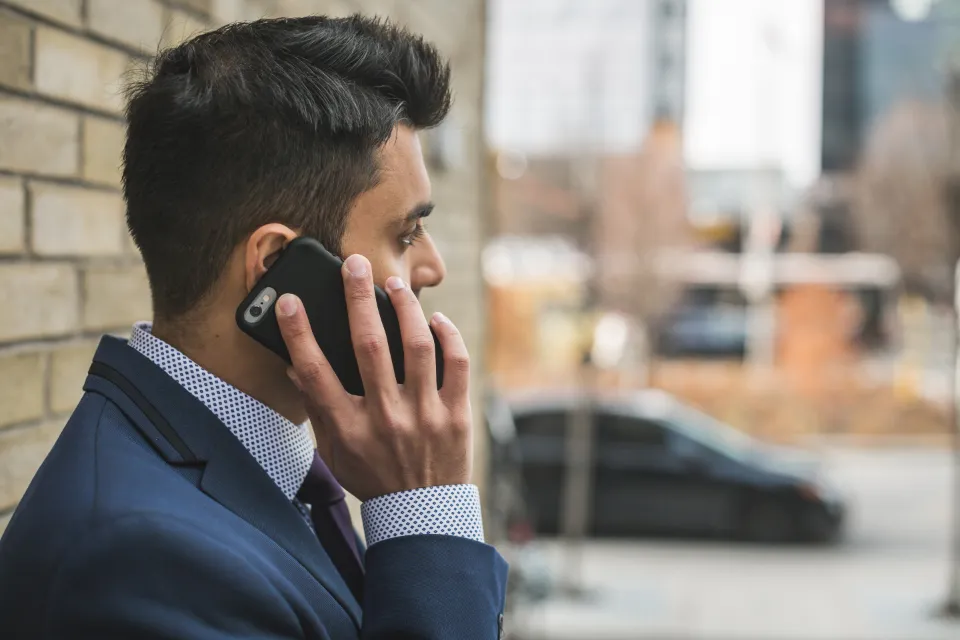A person making a call on a mobile phone