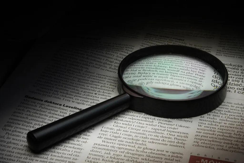 A magnifying glass over printed data, representing keyword research