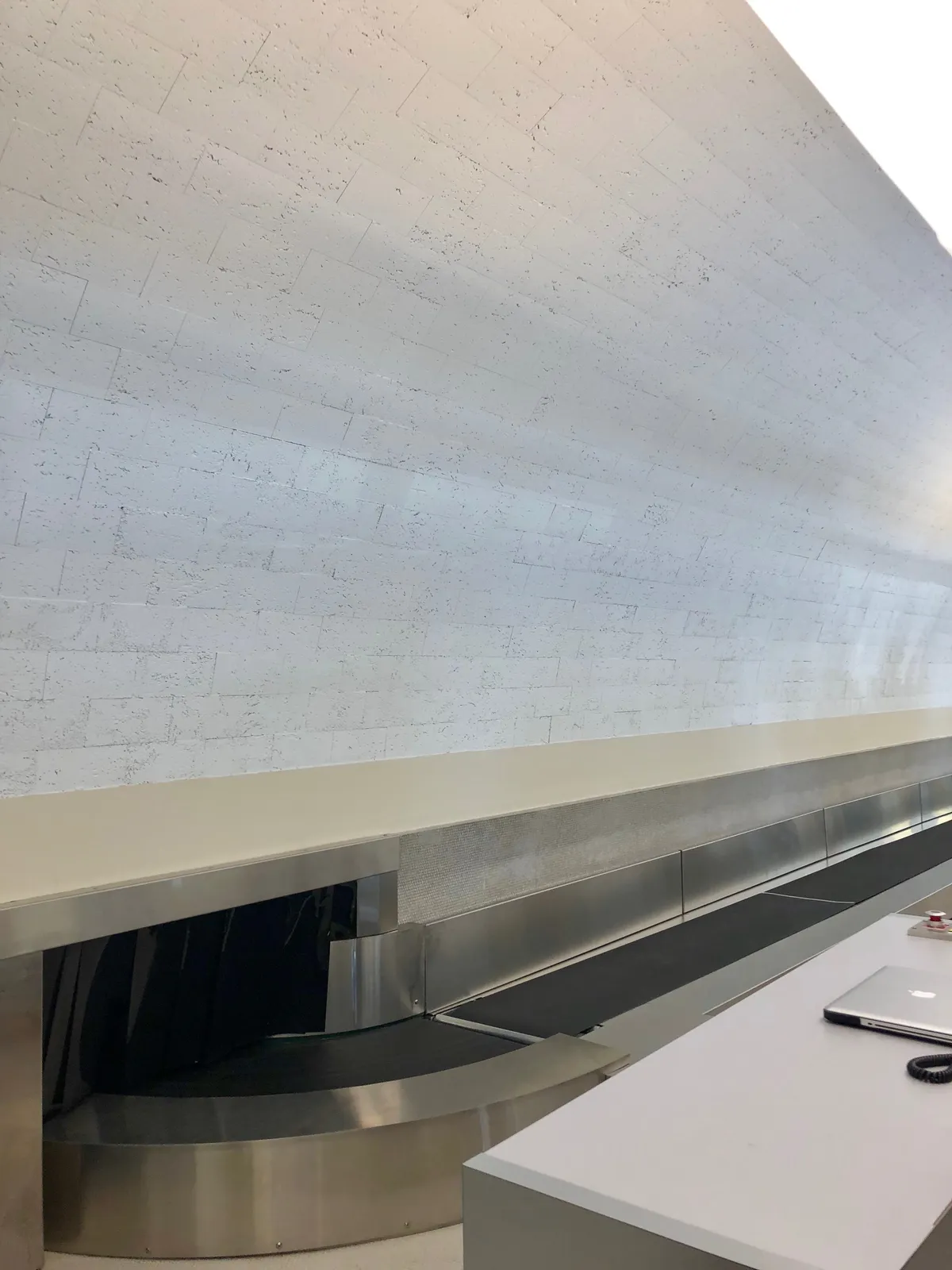 A luggage conveyor belt, representing an asynchronous request-poll-collect pipeline